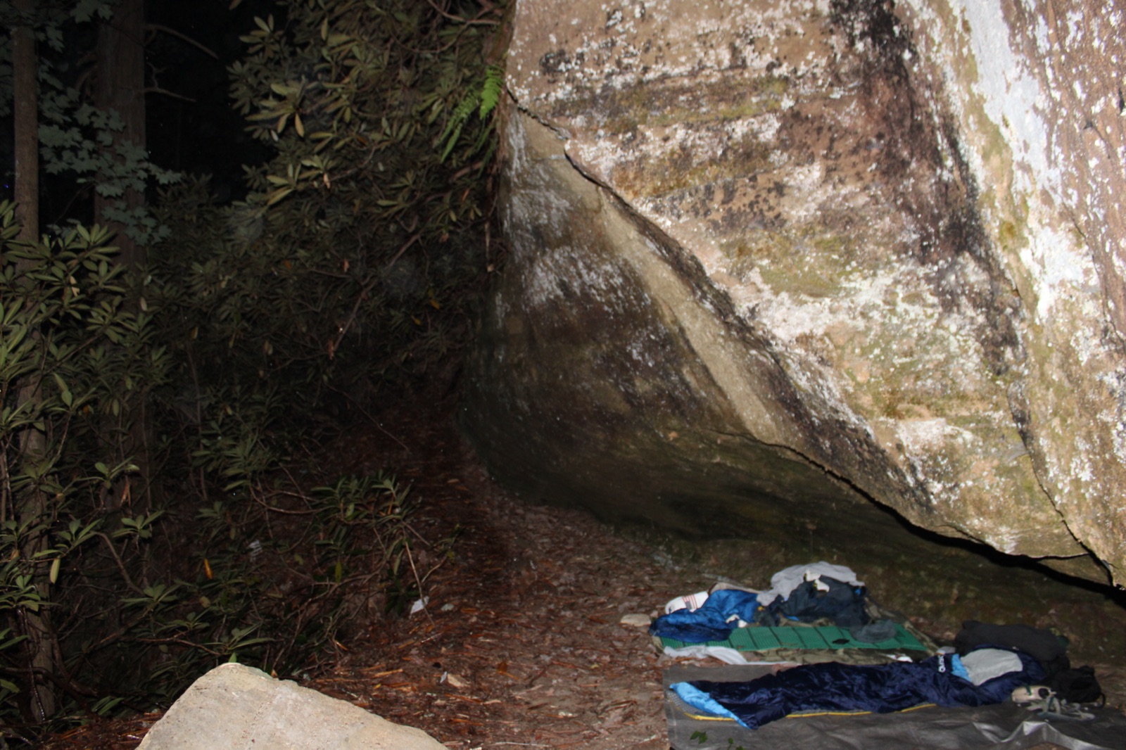 Sleeping bags under rock overhang ,  shelter from the rain