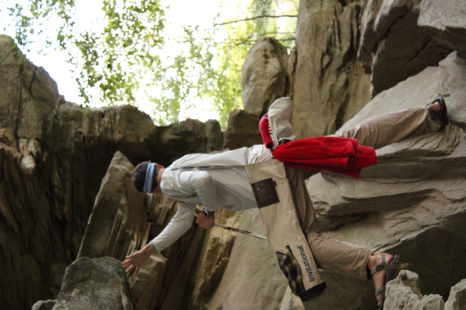 Scrambling through rocks at Whistler's Arch with golf bag